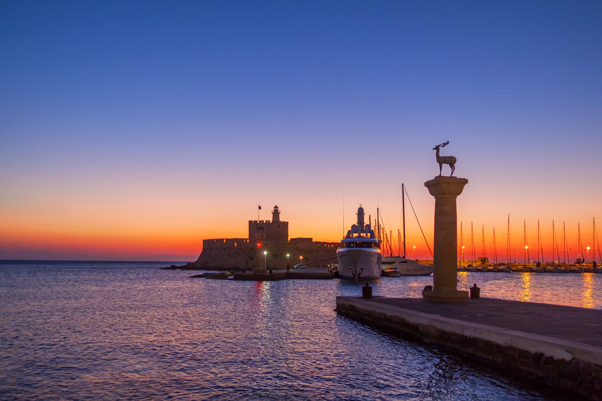 Mandraki Harbour Rhodes with deer statues and medieval windmills Mandraki Harbour Rhodes deer statues medieval windmills waterfront